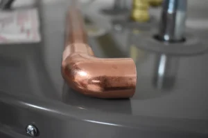 closeup of copper tubing on top of new hot water heater