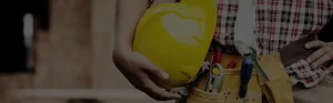 closeup on yellow hard hat carried by plumber