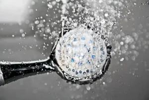 closeup on shower head flowing with water